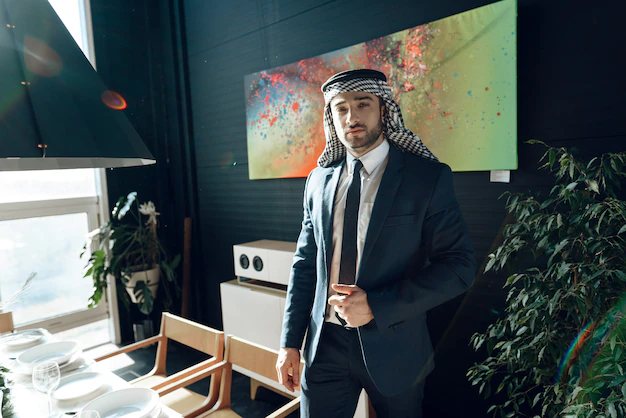 bearded-arab-businessman-suit-standing-near-dinner-table_94347-937